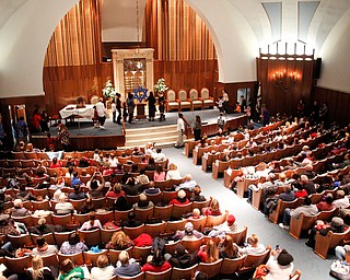 People watch as students from Akiva Academy light the Star of David during the students' Hanukkah program at Congregation Rodef Sholom on Thursday evening. EMILY MATTHEWS | THE VINDICATOR