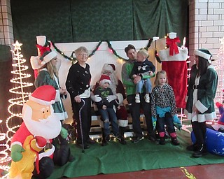 Neighbors | Jessica Harker.Joyce Podgony, who hosted the tree lighting event at the Austintown Fire Department for the past 31 years, posed with Santa Claus and her great grand children Nov. 29.