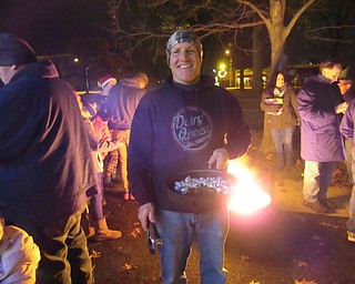 Neighbors | Jessica Harker.Raymond Smith from Dairy Queen in Canfield roasted chestnuts at camp fires outside of the store to give to community members for free on Nov. 30.