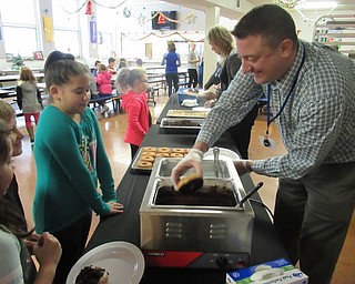 Neighbors | Jessica Harker.Brynn Febinger had her doughnut dipped in chocolate for Poland Union's first Donut Day.