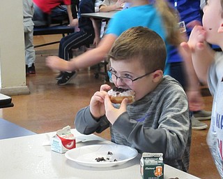 Neighbors | Jessica Harker.Poland Union student Paul Crawford enjoyed a doughnut during the school's first Donut Day on Nov. 30.