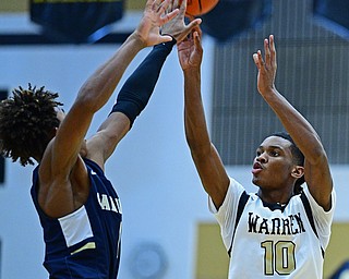 WARREN, OHIO - DECEMBER 6, 2018: Warren Harding's D'Muntize Owens has his shot blocked by Cleveland Heights' Meechie Johnson during the first half of their game Thursday night at Warren Harding High School. DAVID DERMER | THE VINDICATOR