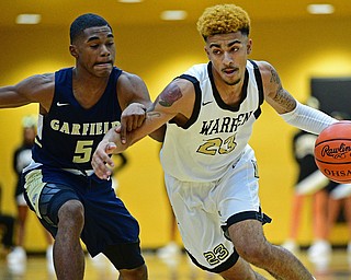 WARREN, OHIO - DECEMBER 6, 2018: Warren Harding's Dom McGhee drives on Cleveland Heights' Ronald Davis during the first half of their game Thursday night at Warren Harding High School. DAVID DERMER | THE VINDICATOR