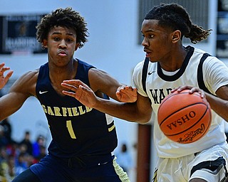 WARREN, OHIO - DECEMBER 6, 2018: Warren Harding's D'Muntize Owens drives on Cleveland Heights' Meechie Johnson during the first half of their game Thursday night at Warren Harding High School. DAVID DERMER | THE VINDICATOR