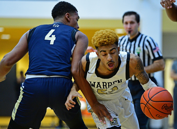 WARREN, OHIO - DECEMBER 6, 2018: Warren Harding's Dom McGhee drives on Cleveland Heights' Brent Darby during the first half of their game Thursday night at Warren Harding High School. DAVID DERMER | THE VINDICATOR