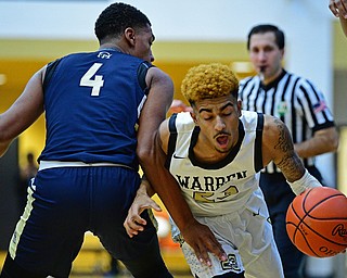 WARREN, OHIO - DECEMBER 6, 2018: Warren Harding's Dom McGhee drives on Cleveland Heights' Brent Darby during the first half of their game Thursday night at Warren Harding High School. DAVID DERMER | THE VINDICATOR