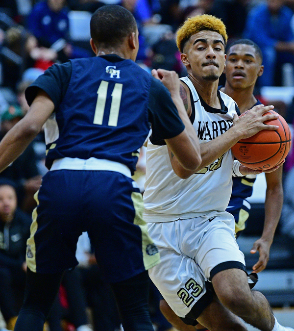 WARREN, OHIO - DECEMBER 6, 2018: Warren Harding's Dom McGhee drives on Cleveland Heights' Sonny Johnson during the first half of their game Thursday night at Warren Harding High School. DAVID DERMER | THE VINDICATOR