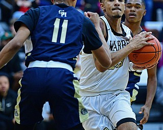 WARREN, OHIO - DECEMBER 6, 2018: Warren Harding's Dom McGhee drives on Cleveland Heights' Sonny Johnson during the first half of their game Thursday night at Warren Harding High School. DAVID DERMER | THE VINDICATOR