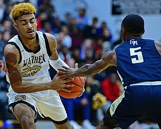 WARREN, OHIO - DECEMBER 6, 2018: Warren Harding's Dom McGhee protects the ball from Cleveland Heights' Ronald Davis during the first half of their game Thursday night at Warren Harding High School. DAVID DERMER | THE VINDICATOR