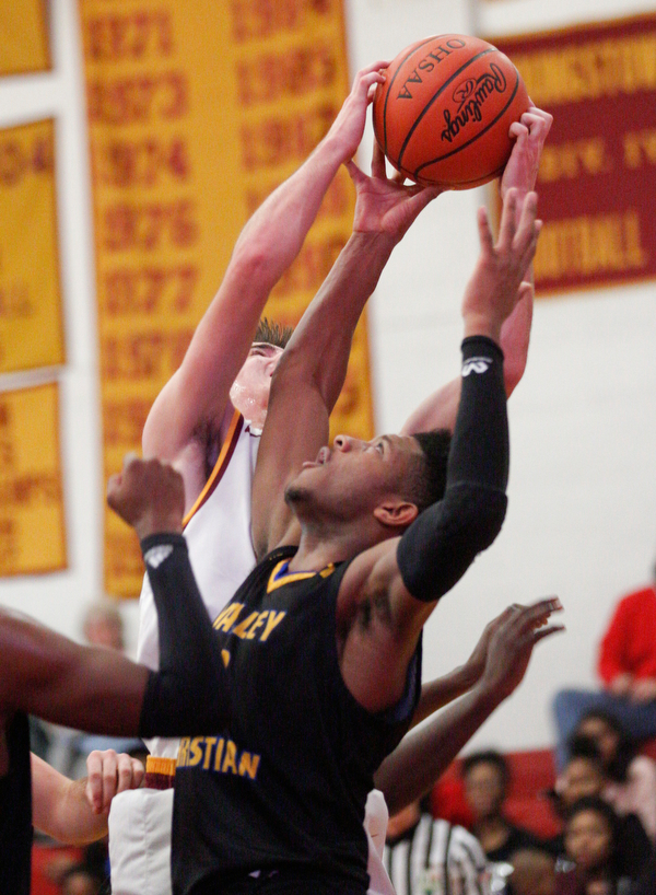 Valley Christian's Jordan Trowers grabs the ball from Cardinal Mooney's Anthony Fire during the second period of their game at Cardinal Mooney on Friday night. EMILY MATTHEWS | THE VINDICATOR