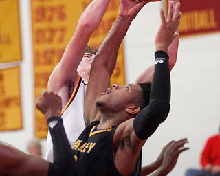 Valley Christian's Jordan Trowers grabs the ball from Cardinal Mooney's Anthony Fire during the second period of their game at Cardinal Mooney on Friday night. EMILY MATTHEWS | THE VINDICATOR