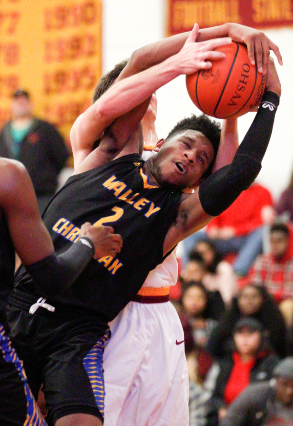 Valley Christian's Jordan Trowers grabs the ball from Cardinal Mooney's Anthony Fire during the second period of their game at Cardinal Mooney on Friday night. EMILY MATTHEWS | THE VINDICATOR