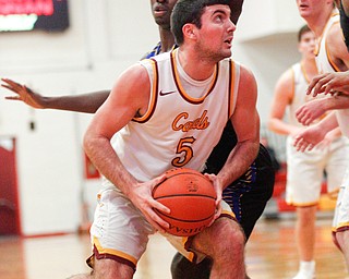 Cardinal Mooney's Pete Haas looks towards the net while  Valley Christian's Damon Christian tries to block him during the first period of their game at Cardinal Mooney on Friday night. EMILY MATTHEWS | THE VINDICATOR