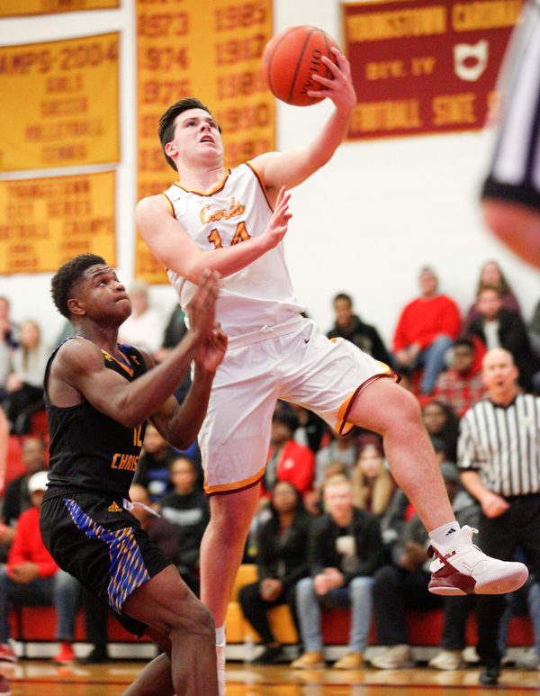 Cardinal Mooney's Mike Pelini prepares to shoot the ball while Valley Christian's Tyrone Lindsey tries to block him during the first period of their game at Cardinal Mooney on Friday night. EMILY MATTHEWS | THE VINDICATOR