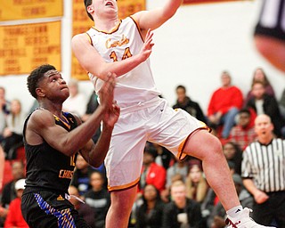 Cardinal Mooney's Mike Pelini prepares to shoot the ball while Valley Christian's Tyrone Lindsey tries to block him during the first period of their game at Cardinal Mooney on Friday night. EMILY MATTHEWS | THE VINDICATOR