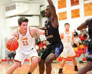 Cardinal Mooney's Anthony Fire tries to get past Valley Christian's Damon Christian during the second period of their game at Cardinal Mooney on Friday night. EMILY MATTHEWS | THE VINDICATOR