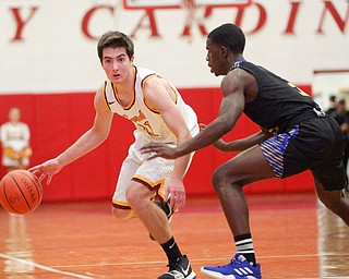 Cardinal Mooney's Anthony Fire looks to pass the ball as he tries to get past Valley Christian's Damon Christian during the second period of their game at Cardinal Mooney on Friday night. EMILY MATTHEWS | THE VINDICATOR