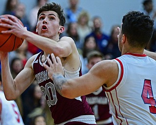 NILES, OHIO - DECEMBER 7, 2018: Boardman's Shay Eicher goes to the basket while being pressured by Niles' Cyler Kane-Johnson during the first half of their game, Friday night at Niles McKinley High School. DAVID DERMER | THE VINDICATOR