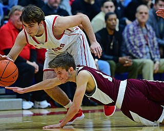 NILES, OHIO - DECEMBER 7, 2018: Niles' Zack Leonard takes the ball away from Boardman's Tommy Fryda as he dives to attempt to prevent a turnover during the first half of their game, Friday night at Niles McKinley High School. DAVID DERMER | THE VINDICATOR