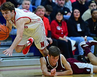 NILES, OHIO - DECEMBER 7, 2018: Niles' Zack Leonard takes the ball away from Boardman's Tommy Fryda as he dives to attempt to prevent a turnover during the first half of their game, Friday night at Niles McKinley High School. DAVID DERMER | THE VINDICATOR