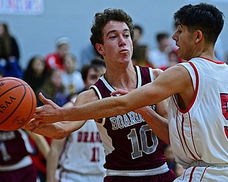 NILES, OHIO - DECEMBER 7, 2018: Boardman's Zack Ryan passes the ball while being pressured by Niles' Vincent Chieffo during the first half of their game, Friday night at Niles McKinley High School. DAVID DERMER | THE VINDICATOR