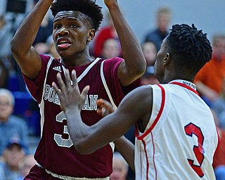 NILES, OHIO - DECEMBER 7, 2018: Boardman's Derrick Anderson goes to the basket while being pressured by Niles' Jalen Royal-Eiland during the first half of their game, Friday night at Niles McKinley High School. DAVID DERMER | THE VINDICATOR