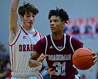 NILES, OHIO - DECEMBER 7, 2018: Boardman's Daeone Martin drives on Niles' Trent Johnson during the first half of their game, Friday night at Niles McKinley High School. DAVID DERMER | THE VINDICATOR