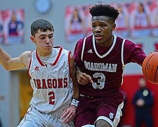 NILES, OHIO - DECEMBER 7, 2018: Boardman's Derrick Anderson drives on Niles' Doug Foster during the first half of their game, Friday night at Niles McKinley High School. DAVID DERMER | THE VINDICATOR