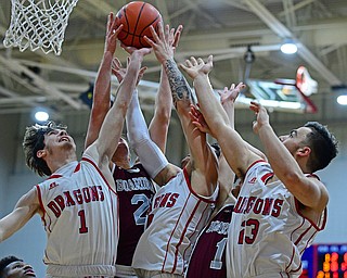 NILES, OHIO - DECEMBER 7, 2018: (LtoR) Niles Trent Johnson, Cyler Kane-Johnson and Joe Corson battle with Boardman's Cam Kreps and Tommy Fryda for a rebound during the second half of their game, Friday night at Niles McKinley High School. DAVID DERMER | THE VINDICATOR