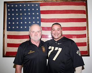 Jim Grossman, left, the Post Commander at the Farrell VFW 5286, and Frank Zelinsky, his Senior Vice and the organizer of the watch party for the Army vs. Navy football game, pose for a photo in front of a 48-star flag and the VFW on Saturday afternoon. Grossman said the watch party focuses on the camaraderie between veterans, and Zelinsky said he wants the VFW to be the place for community members to come together to watch the Army and Navy game every year. EMILY MATTHEWS | THE VINDICATOR