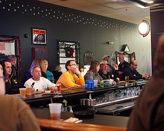 People watch the Army vs. Navy football game at the Farrell VFW 5286 on Saturday afternoon. Frank Zelinsky, who organized the second annual watch party, said he wants the VFW to be the place for community members to come together to watch the Army and Navy game every year. EMILY MATTHEWS | THE VINDICATOR