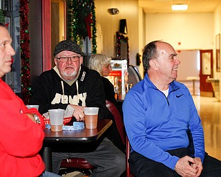 From left, Don Bochert, Allen Altham, and Carmen Schuville, all of Farrell, watch the Army vs. Navy football game at the Farrell VFW 5286 on Saturday afternoon. EMILY MATTHEWS | THE VINDICATOR