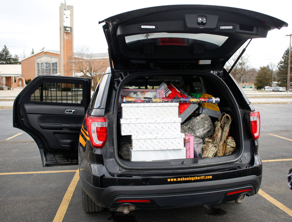 A Mahoning County Sheriff's cruiser is filled with toys at Youngstown Police Department's fourth annual fill a cruiser campaign in the St. Christine Church parking lot on Saturday afternoon. EMILY MATTHEWS | THE VINDICATOR