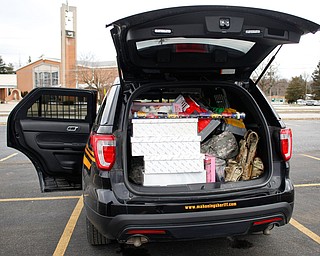 A Mahoning County Sheriff's cruiser is filled with toys at Youngstown Police Department's fourth annual fill a cruiser campaign in the St. Christine Church parking lot on Saturday afternoon. EMILY MATTHEWS | THE VINDICATOR