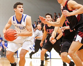 Poland's Braeden O'Shaughnessy looks to the hoop while Canfield's Aydin Hanousek tries to block him during their game at Poland Seminary High School on Saturday night. EMILY MATTHEWS | THE VINDICATOR