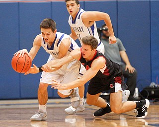 Canfield's Brent Hermann falls as he tries to get the ball away from Poland's Michael Cougras during their game at Poland Seminary High School on Saturday night. EMILY MATTHEWS | THE VINDICATOR