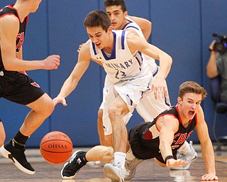 Canfield's Brent Hermann falls as he tries to get the ball away from Poland's Michael Cougras during their game at Poland Seminary High School on Saturday night. EMILY MATTHEWS | THE VINDICATOR