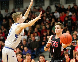 Canfield's Brent Hermann passes the ball while Poland's Jacob Hryb tries to block him during their game at Poland Seminary High School on Saturday night. EMILY MATTHEWS | THE VINDICATOR