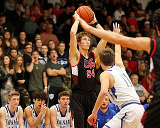 Canfield's Kyle Gamble looks to pass the ball while Poland's Collin Todd tries to block him during their game at Poland Seminary High School on Saturday night. EMILY MATTHEWS | THE VINDICATOR