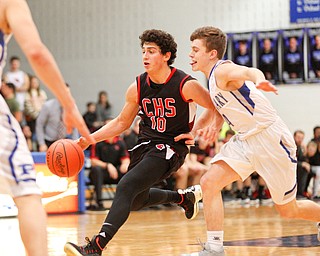 Canfield's Conor Crogan dribbles the ball while Poland's Jeff McAuley tries to block him during their game at Poland Seminary High School on Saturday night. EMILY MATTHEWS | THE VINDICATOR