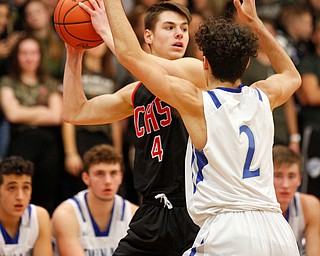 Canfield's Jake Kowal looks to pass the ball while Poland's Andrew Centofanti tries to block him during their game at Poland Seminary High School on Saturday night. EMILY MATTHEWS | THE VINDICATOR