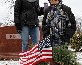 Brandy Hinkle (left) and her son Blake both of Jackson Milton close there eyes while showing respect to the grave of a veteran after they laid a wreath at the site at the North Jackson Cemetary on Saturday morning. Dustin Livesay  |  The Vindicator  12/8/18  North Jackson