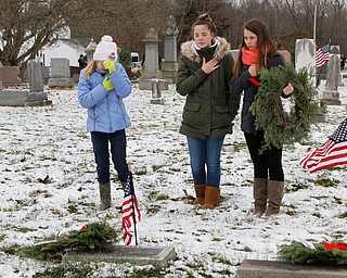 L-R) Blythe Sithian (10) of Berlin Center, Josie Baird (13) of Elsworth, and Karlee Banks (17) of North Jackson show respect after laying wreaths on a pair of veterans graves during a ceremony at the North Jackson Cemetary on Saturday morning. Dustin Livesay  |  The Vindicator  12/8/18  North Jackson