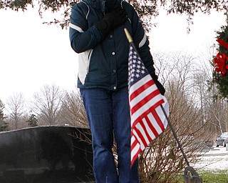 Marybeth Steffan of Rogers covers her heart to honor the grave of a veteran that she laid a wreath on at the North Jackson Cemetary on Saturdat morning. Dustin Livesay  |  The Vindicator  12/8/18  North Jackson