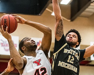 DIANNA OATRIDGE | THE VINDICATOR  Youngstown State's Alex Holcombe (42) puts up a shot over Western Michigan defender Michael Flowers (12) during their game at Beeghly Center on Saturday.