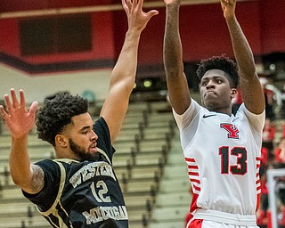 DIANNA OATRIDGE | THE VINDICATOR  Youngstown State's Antwan Donel Cathcart (13) shoots a jumper against Western Michigan defender Michael Flowers (12) during their game at Beeghly Center on Saturday.