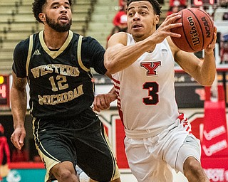 DIANNA OATRIDGE | THE VINDICATOR  Youngstown State's Darius Quisenberry (3) drives the lane against Western Michigan's Michael Flowers (12) during their game at Beeghly Center on Saturday.