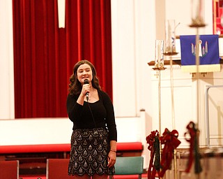 Ava Wilson, a high school sophomore from Poland, sings When Christmas Comes to Town as part of the Concerts Under the Dome at First Presbyterian Church in Columbiana on Sunday night. EMILY MATTHEWS | THE VINDICATOR