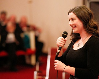 Ava Wilson, a high school sophomore from Poland, smiles after singing Let it Snow as part of the Concerts Under the Dome at First Presbyterian Church in Columbiana on Sunday night. EMILY MATTHEWS | THE VINDICATOR