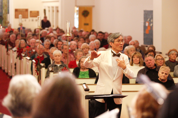 Dr. Hae-Jong Lee directs the Stambaugh Chorus in performing Wishes and Candles as part of the Concerts Under the Dome at First Presbyterian Church in Columbiana on Sunday night. EMILY MATTHEWS | THE VINDICATOR